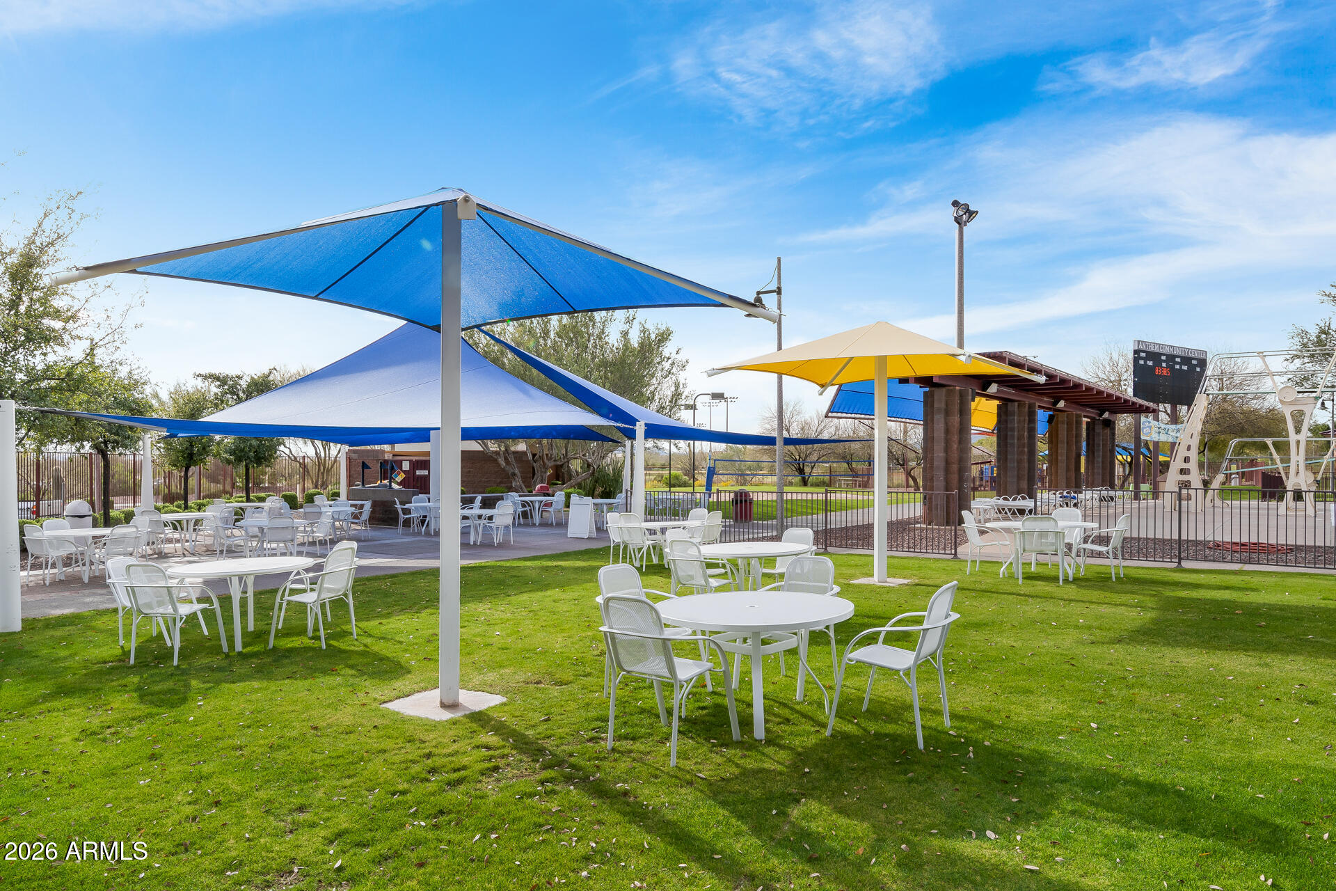 41712 North Golf Crest Road Anthem, AZ 85086 - Photo 32 of 39 a view of a chairs and table under an umbrella in backyard