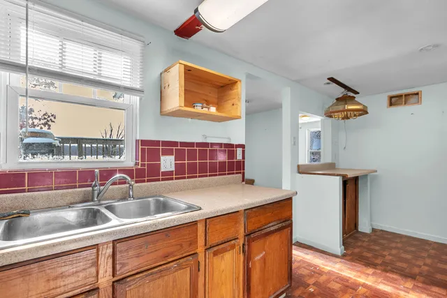 a kitchen with stainless steel appliances granite countertop a sink and a microwave