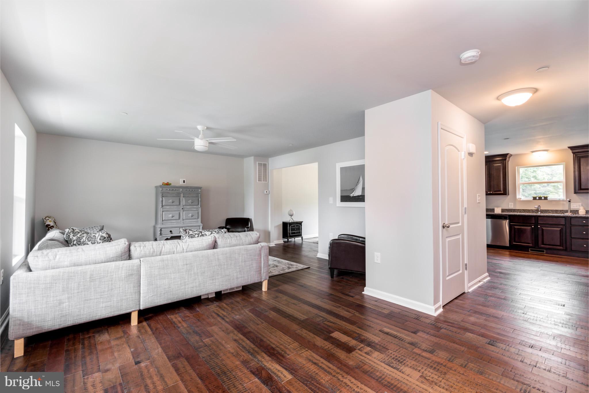 8035 Clark Station Road Severn, MD 21144 - Photo 2 of 24 a living room with furniture and a wooden floor