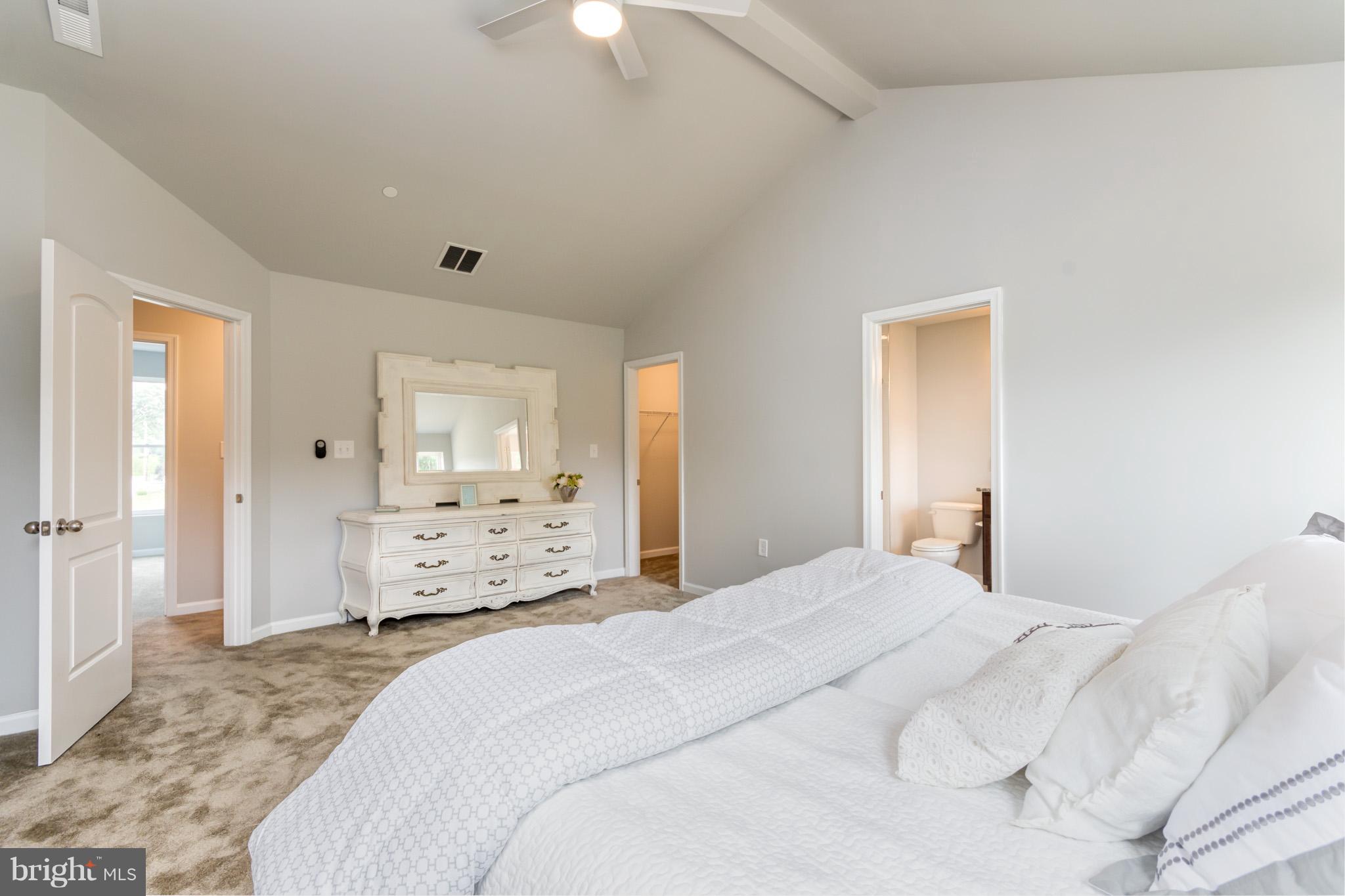 8035 Clark Station Road Severn, MD 21144 - Photo 12 of 24 a bedroom with a bed and a large mirror