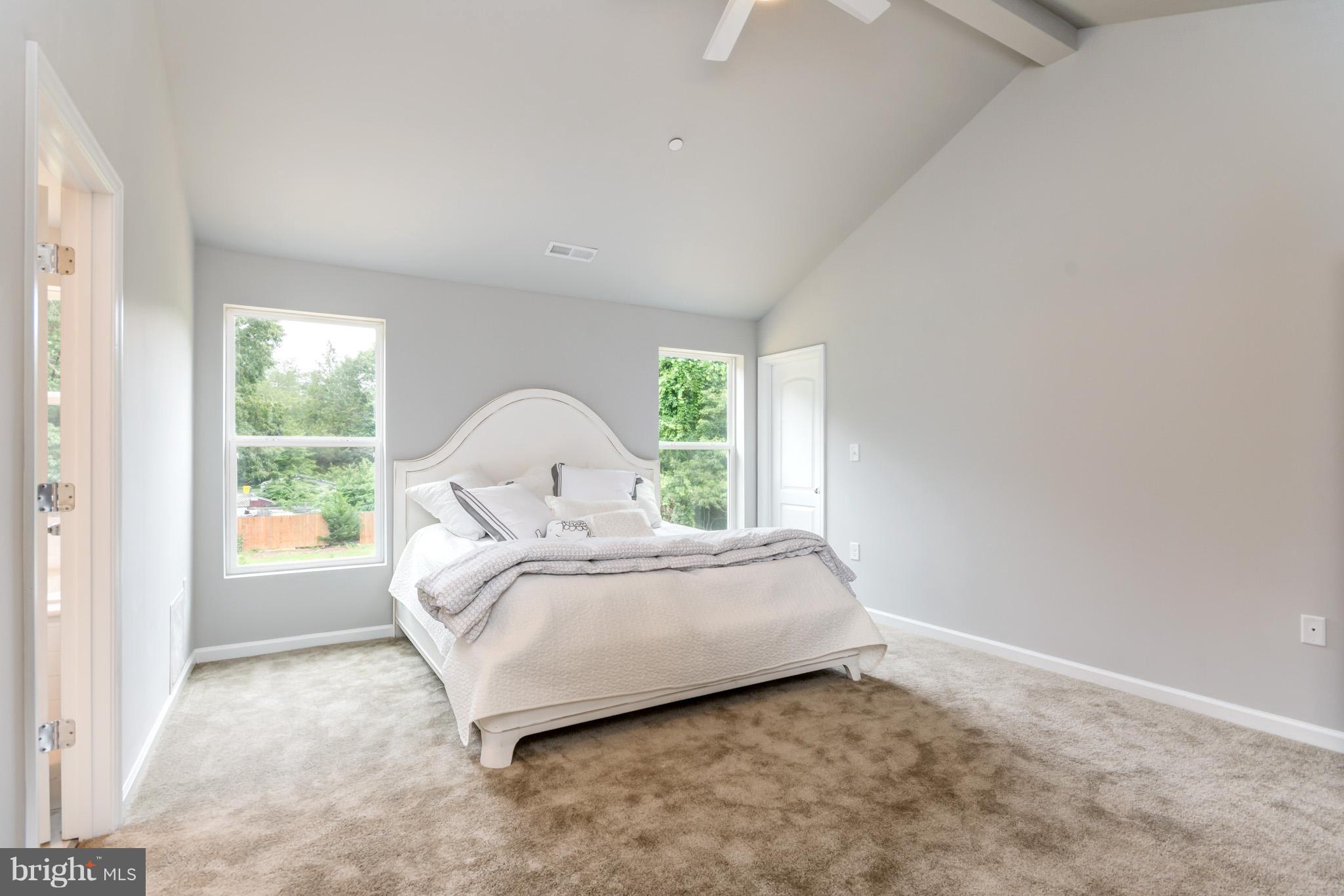 8035 Clark Station Road Severn, MD 21144 - Photo 13 of 24 a bed sitting in a spacious bedroom next to a window