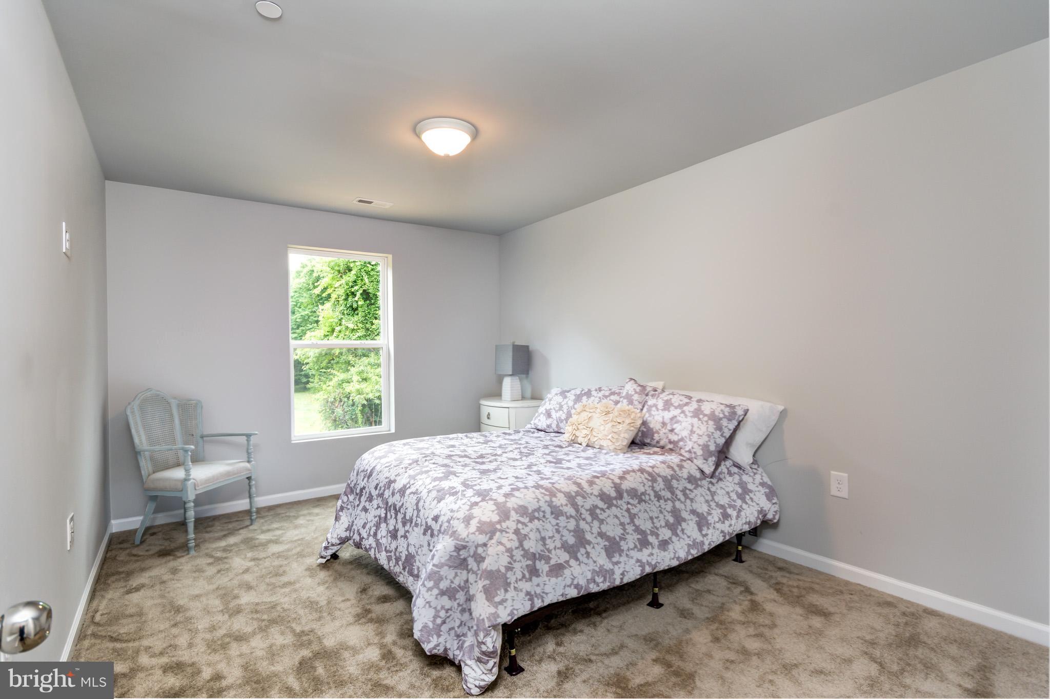 8035 Clark Station Road Severn, MD 21144 - Photo 17 of 24 a bedroom with a bed and a window