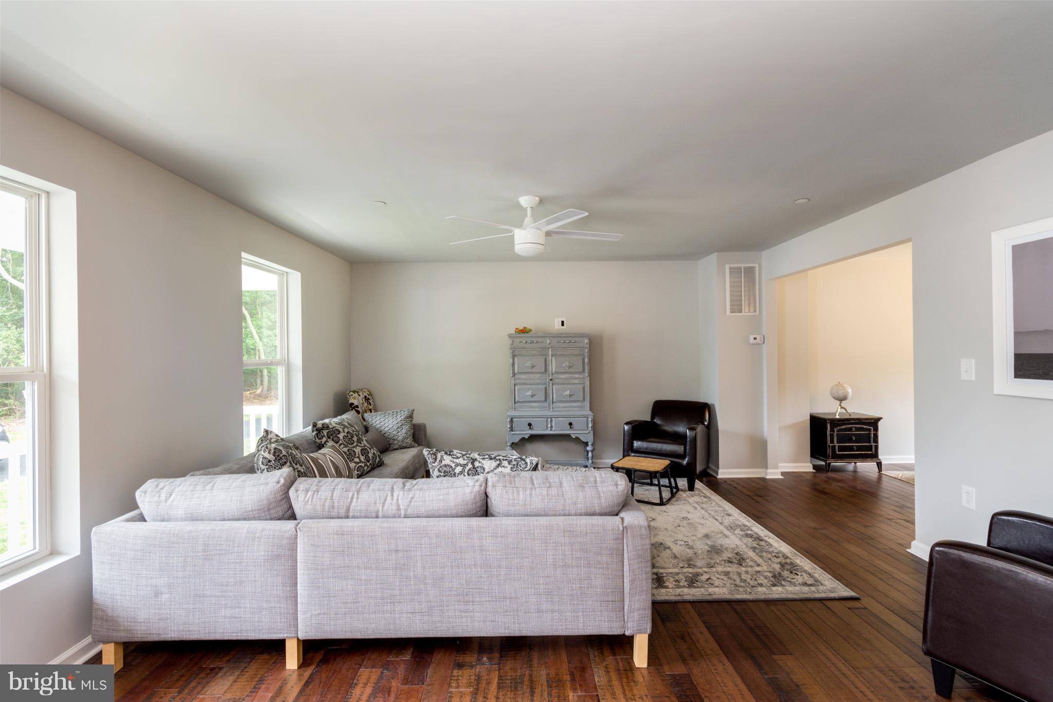 8035 Clark Station Road Severn, MD 21144 - Photo 3 of 24 a living room with furniture and wooden floor