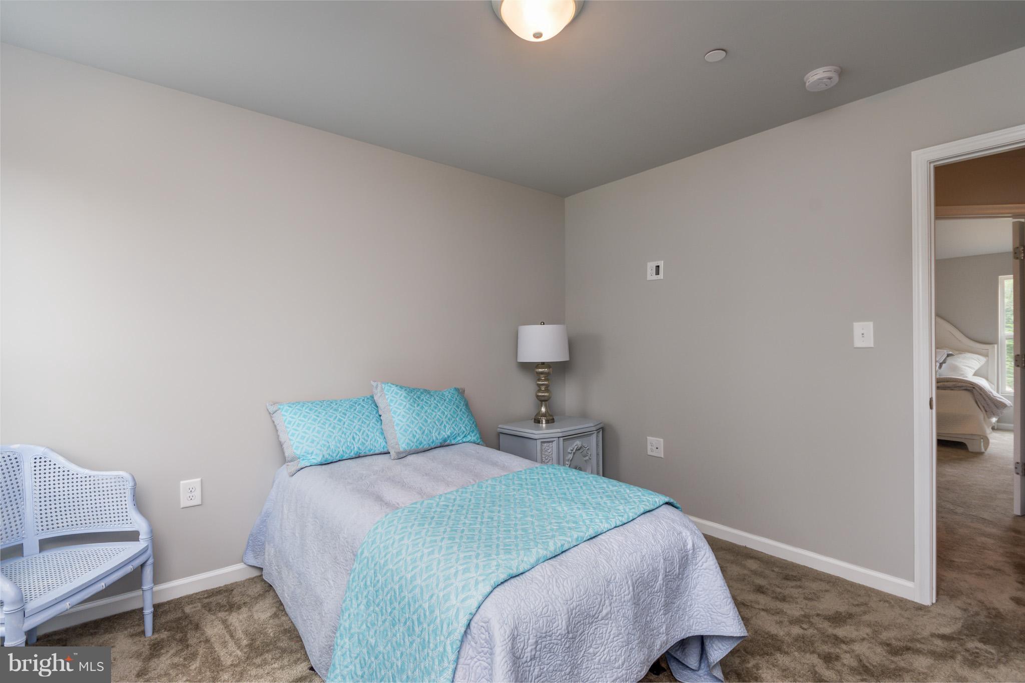 8035 Clark Station Road Severn, MD 21144 - Photo 21 of 24 a bedroom with a bed and a couch