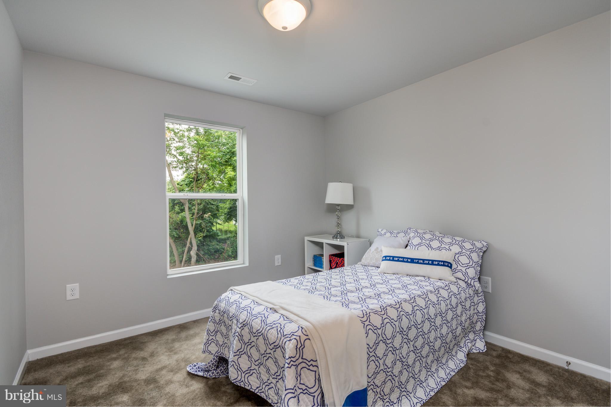 8035 Clark Station Road Severn, MD 21144 - Photo 22 of 24 a bedroom with a bed and a window