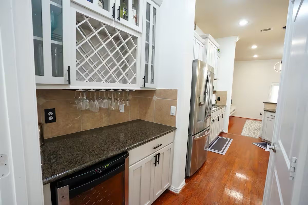 5625 Dolores Street, Unit B Houston, TX 77057 - Photo 11 of 40 a kitchen with stainless steel appliances granite countertop a refrigerator and a stove