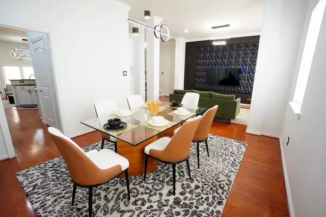 a dining room with furniture and wooden floor