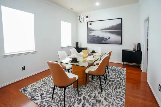 a dining room with furniture and wooden floor