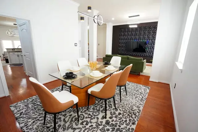 a dining room with furniture and wooden floor