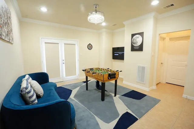a living room with furniture and a chandelier