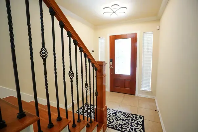 a view of entryway with stairs and wooden floor
