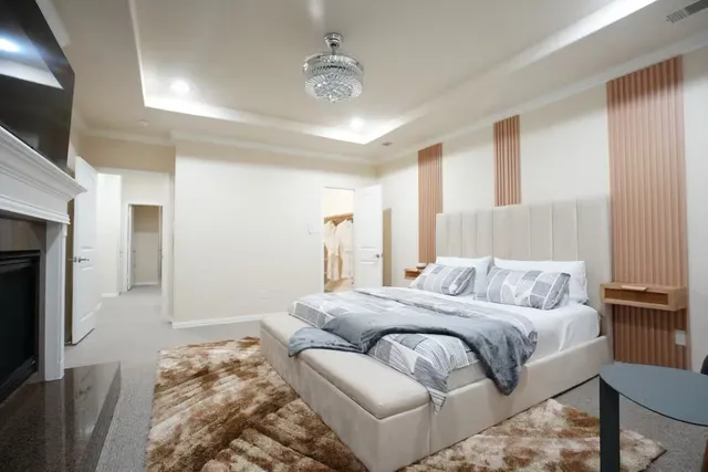 a bedroom with a large bed and a flat screen tv