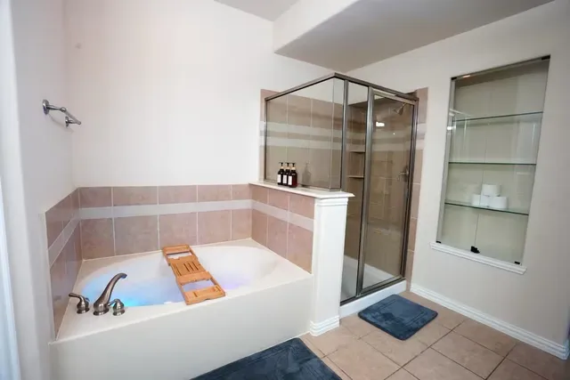 a bathroom with a tub and shower