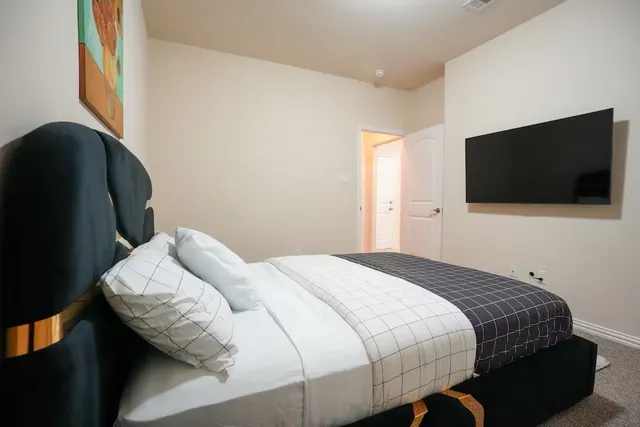 a bedroom with bed and a chandelier