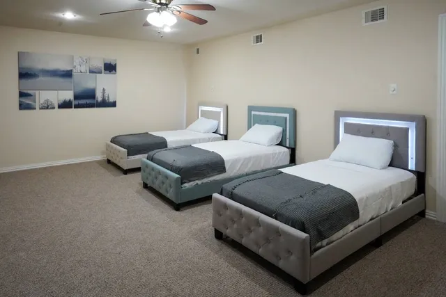 a bedroom with a large bed and a chandelier