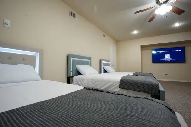 a bathroom with double vanity sinks a mirror and a shower