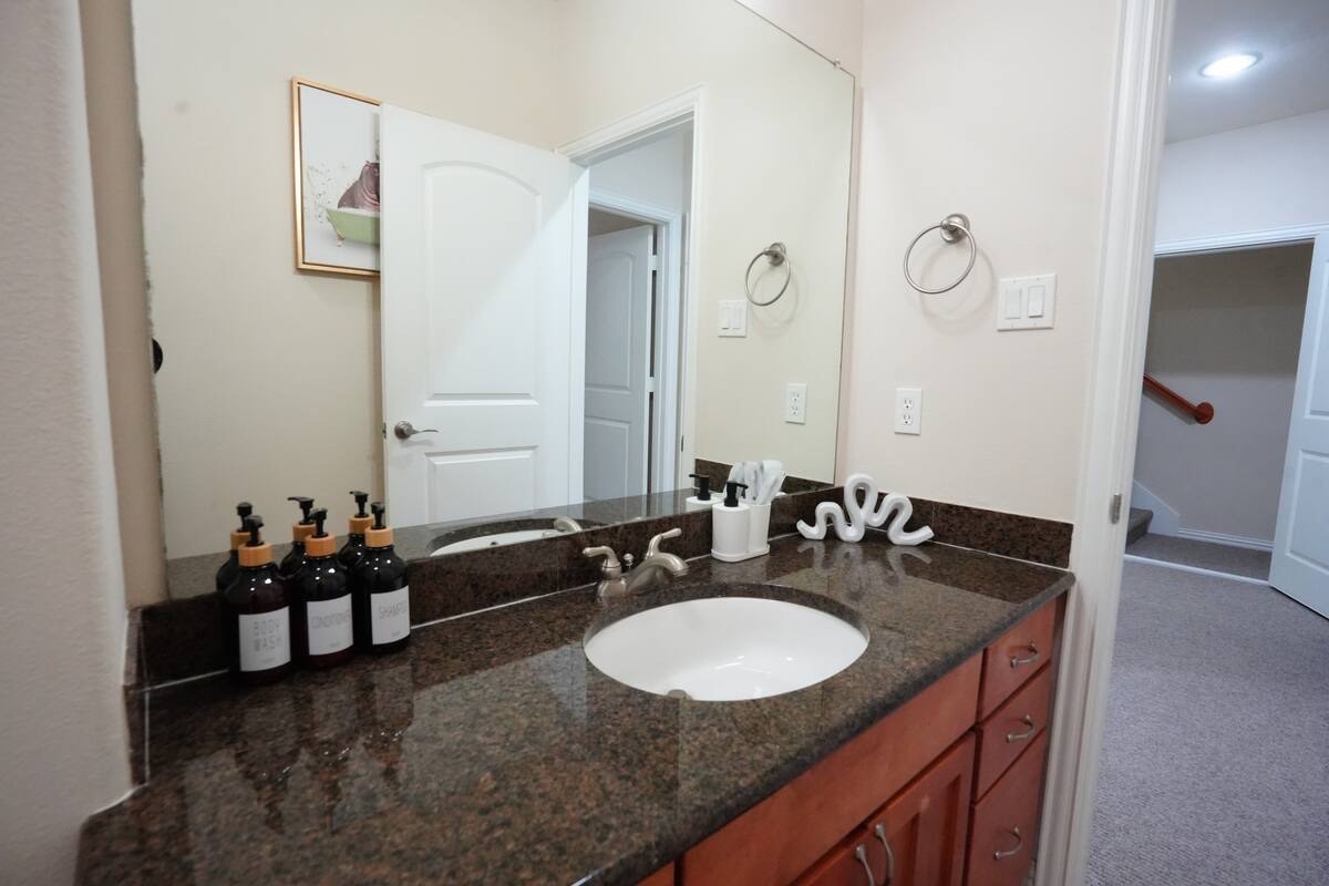 5625 Dolores Street, Unit B Houston, TX 77057 - Photo 37 of 40 a bathroom with double vanity sinks a mirror and a shower