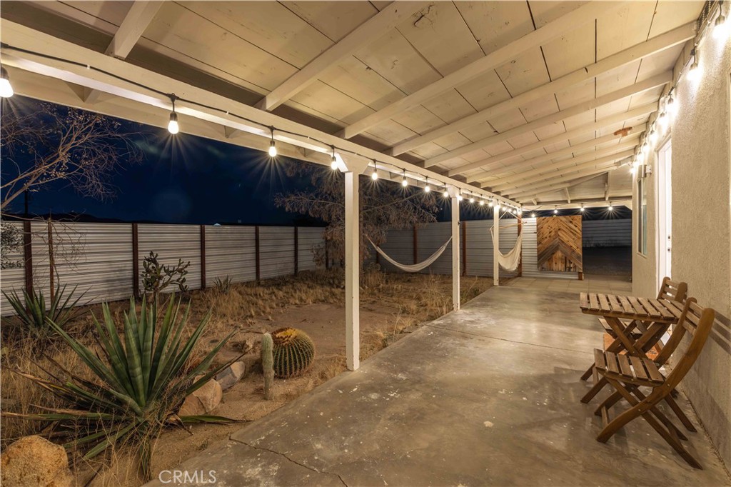 61879 Valley View Circle Joshua Tree, CA 92252 - Photo 44 of 63 a view of a porch with a table and chairs