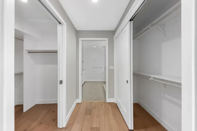 a view of a hallway with wooden floor