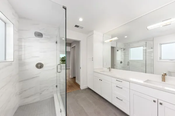 a bathroom with a double vanity sink mirror double shower