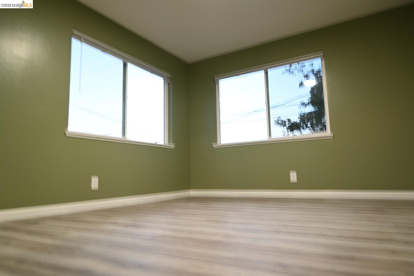 1316 Russell Street Berkeley, CA 94702 - Photo 20 of 23 an empty room with wooden floor and windows