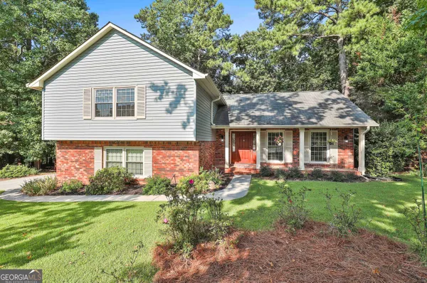 a front view of a house with garden and porch