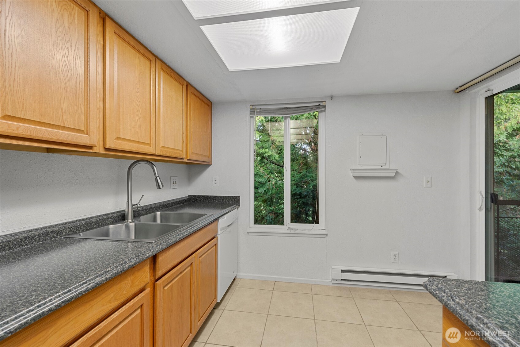 17514 151st Avenue Southeast, Unit I16 Renton, WA 98058 - Photo 12 of 16 a kitchen with granite countertop a sink a counter top space and cabinets