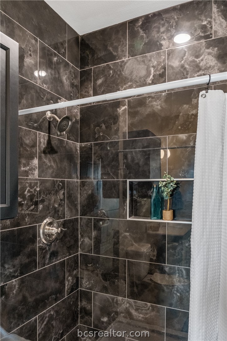 800 North Parker Avenue Bryan, TX 77803 - Photo 12 of 13 a bathroom with a glass shower door