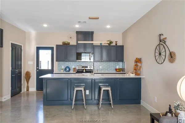 a kitchen with cabinets and a refrigerator