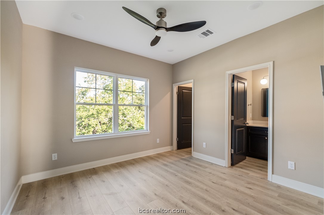 800 North Parker Avenue Bryan, TX 77803 - Photo 6 of 13 a view of empty room with wooden floor and ceiling fan