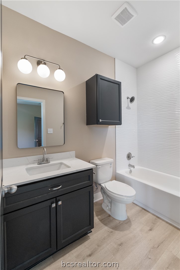 800 North Parker Avenue Bryan, TX 77803 - Photo 7 of 13 a bathroom with a toilet sink and mirror