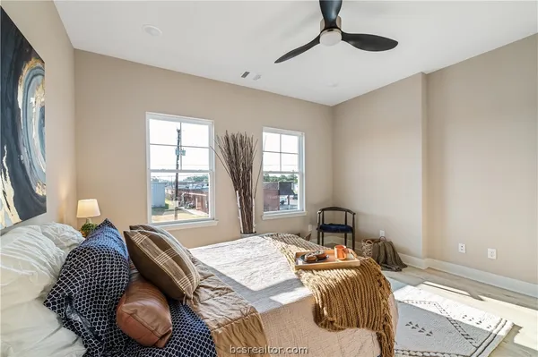 a bedroom with a bed and a chandelier