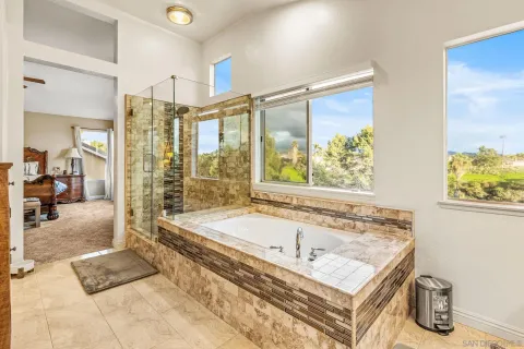 a spacious bathroom with a tub and shower