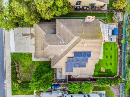 a aerial view of a house with a yard and potted plants