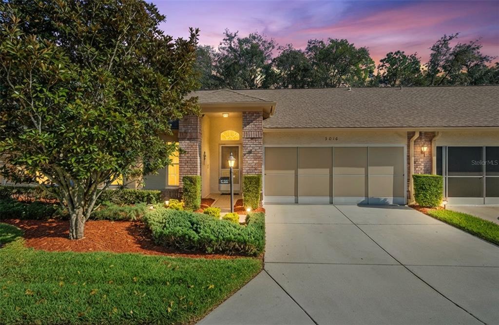 3018 Appleblossom Trail Spring Hill, FL 34606 - Photo 1 of 1 a front view of a house with a yard and trees