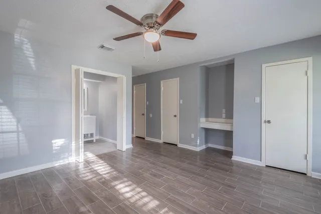 a view of livingroom with hardwood floor and a ceiling fan