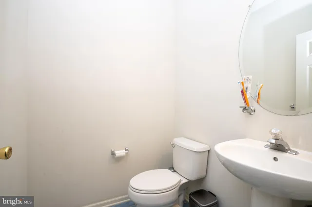 a white toilet sitting next to a bathroom sink
