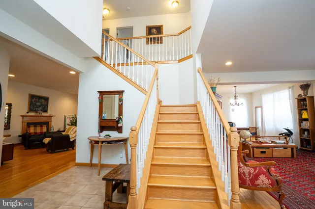 a view of entryway livingroom and hall with wooden floor