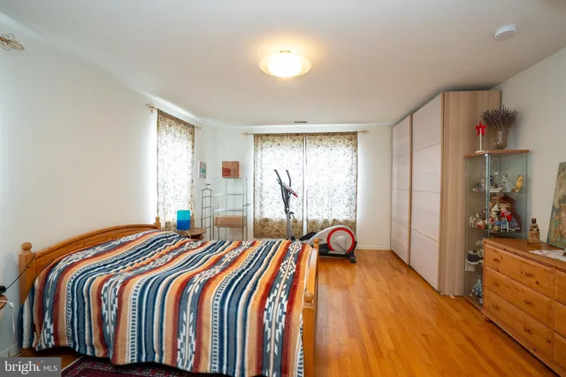 a bedroom with a bed and a large window