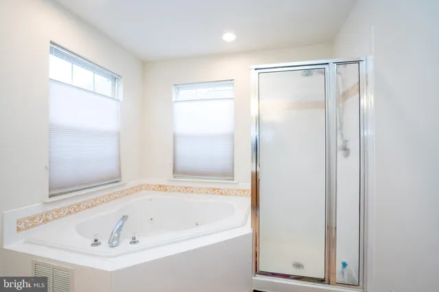 a white bath tub sitting next to a shower