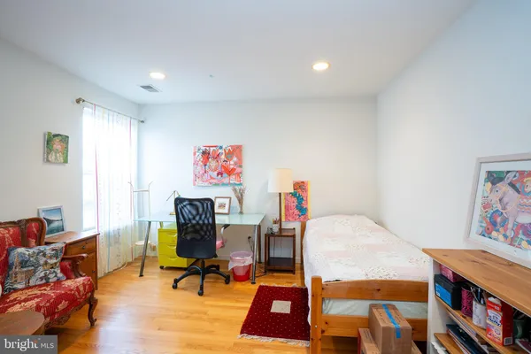 a living room with furniture and a bookshelf