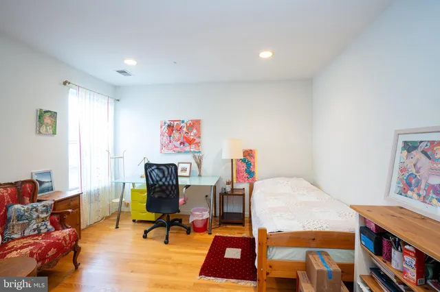 a living room with furniture and a bookshelf