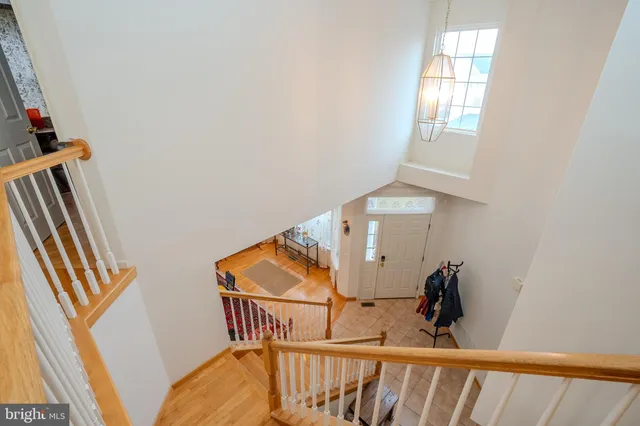a view of stairs and an entryway with wooden floor