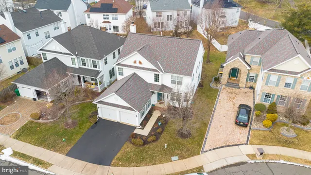an aerial view of residential houses with outdoor space and parking