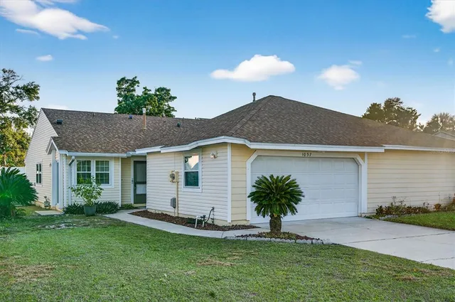 a front view of house with yard and outdoor seating