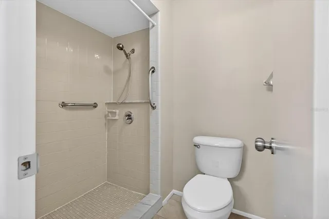 a white toilet sitting next to a bathroom sink