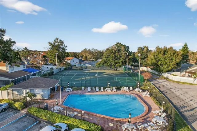 a view of a lake with a yard and outdoor seating