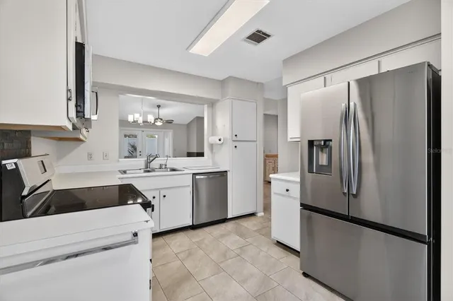 a kitchen with a refrigerator sink and stove