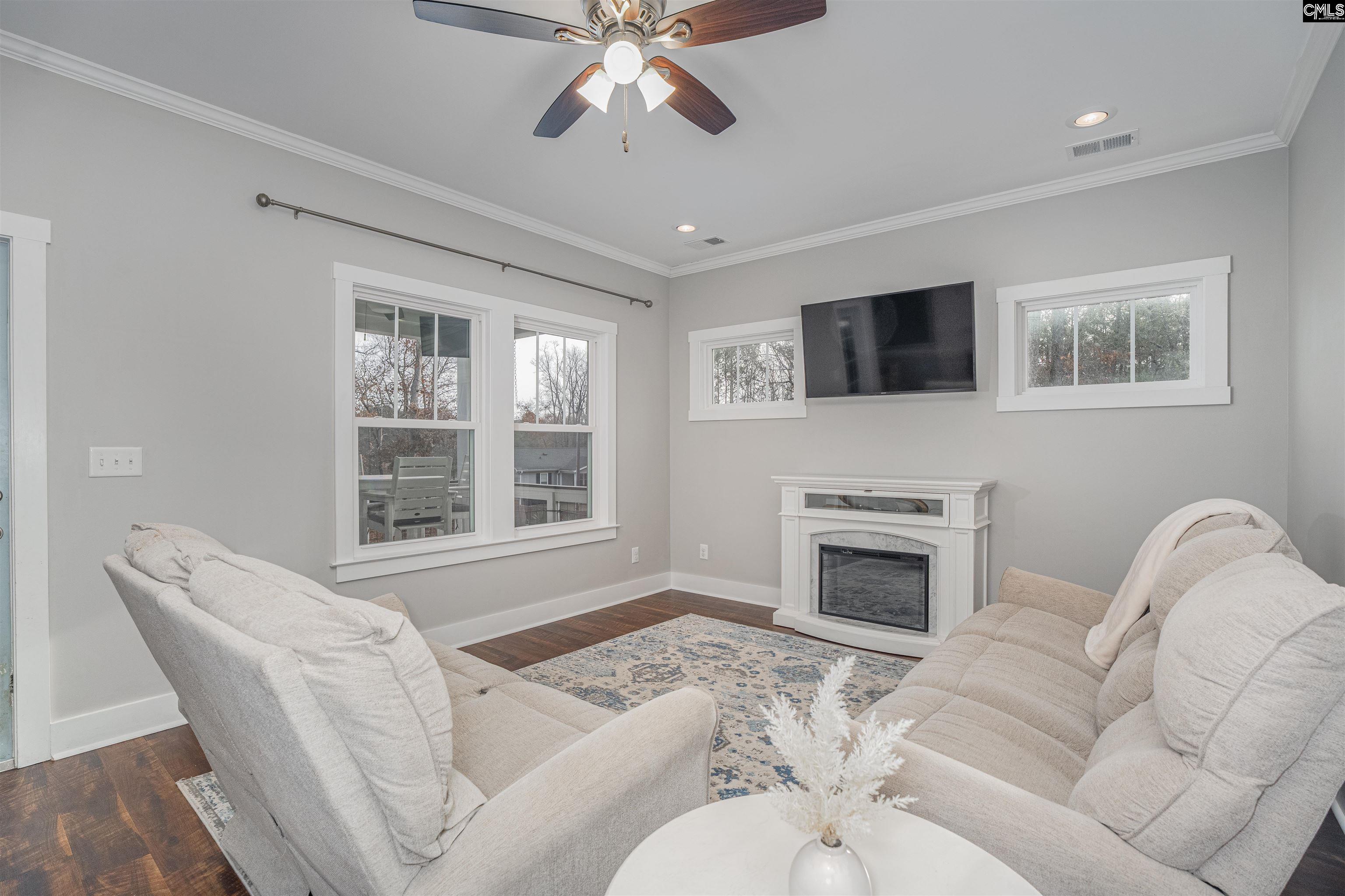 649 Sandbar Road Chapin, SC 29036 - Photo 8 of 40 a living room with furniture a fireplace and a flat screen tv