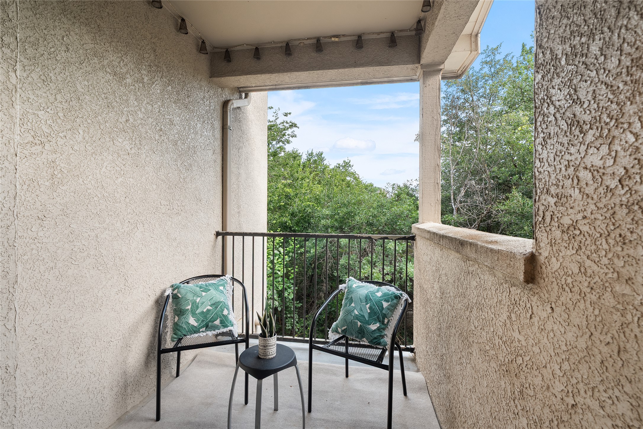 11203 Ranch Road 2222, Unit 1402 Austin, TX 78732 - Photo 8 of 22 A tranquil balcony on the second level retreat overlooking a verdant tree line awaits for quiet mornings.